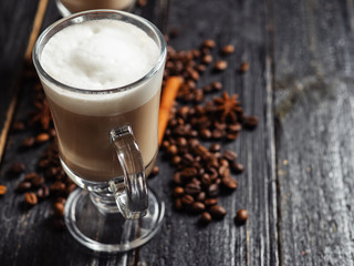 Irish coffee in a glass of liquor and a creamy froth cap