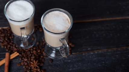 Irish coffee in a glass of liquor and a creamy froth cap