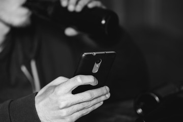 Drunk man with a bottle on the phone. Alcoholism, depression and problems in life
