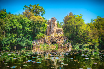 Villa Demidoff Pratolino park and the Colosso del Appennino colossus statue with pond full of...