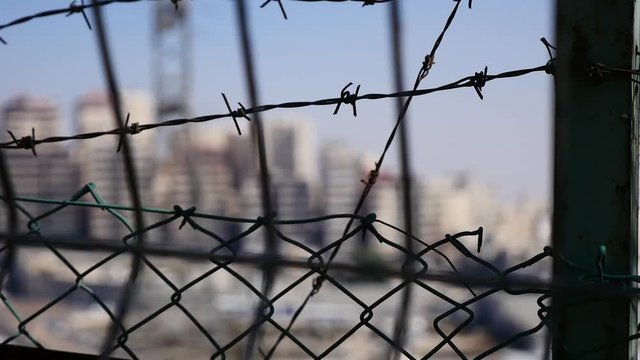 Landscape video photography of East Jerusalem. behind a barbed wire fence. HD