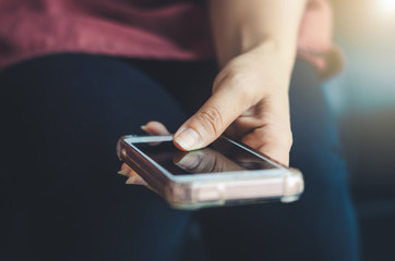 hipster woman using hands touching and typing on mobile phone screen search internet online working or social communication with digital technology app device in coffee shop indoor vintage lifestyle.
