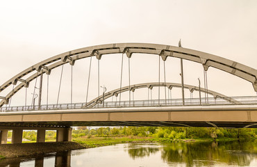brest Republic of Belarus - Old arch metallic bridge of gray color across the river Brest republic Belarus-may 2016