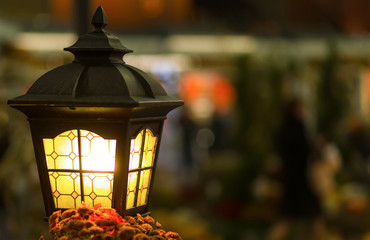 Magic street lamp close-up with copyspace. Warm lantern light on a blurry background