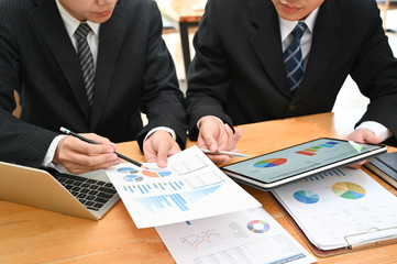 Business consult, Businessman working with finance document and tablet with meeting and planning.