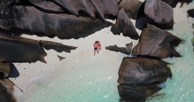 Aerial Ascending: Woman Kissing Man on the Beach of La Digue Seychelles