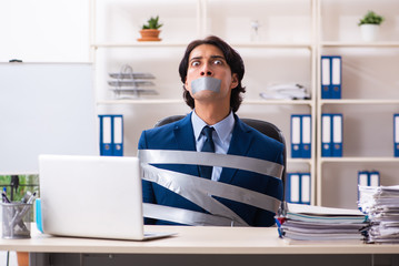 Young tied male employee in the office 