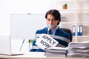 Young tied male employee in the office 