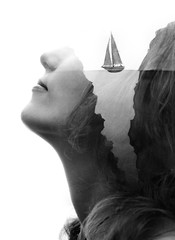 Paintography. Double exposure close up of a woman combined with hand drawn painting of sailboat...