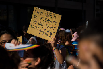People on a gay pride holding poster