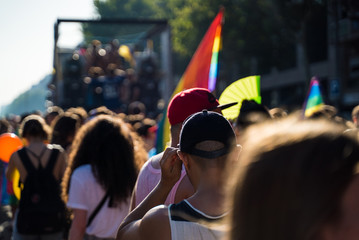 A crowd with rainbow flags is celebrating Pride in Barcelona. LGBTQ Celebration in catalan capital. Gay parade, barcelona.