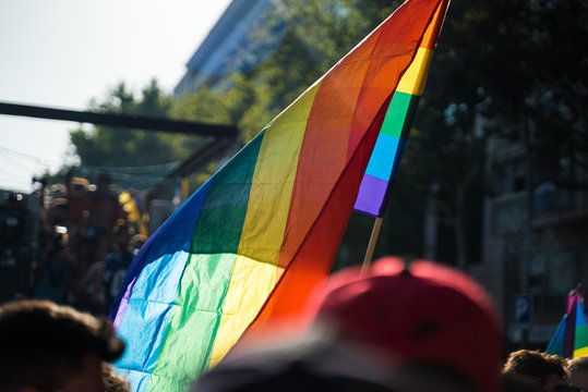 LGTBQ Flag on the blue sky. Rainbow flag over the Barcelona during Gay Pride parade.