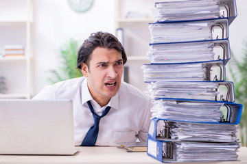 Young male employee unhappy with excessive work