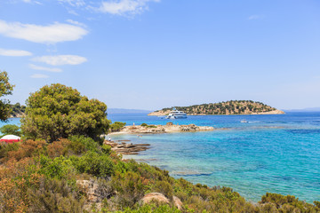 Fototapeta premium Wonderful summer seascape of turquoise sea water and yacht at coast Sithonia on Halkidiki Greece