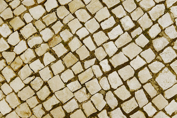 Old beige stone pavement background