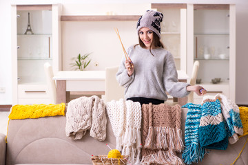 Young beautiful woman knitting at home