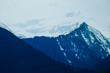 Naklejka na ściany i meble High alpine Himalayan mountain snow peak landscape, beautiful natural winter backdrop. Ice hill top, cloudy sky background.