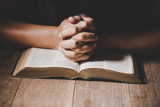 Christian life crisis prayer to god. Woman Pray for god blessing to wishing have a better life. woman hands praying to god with the bible. begging for forgiveness and believe in goodness.