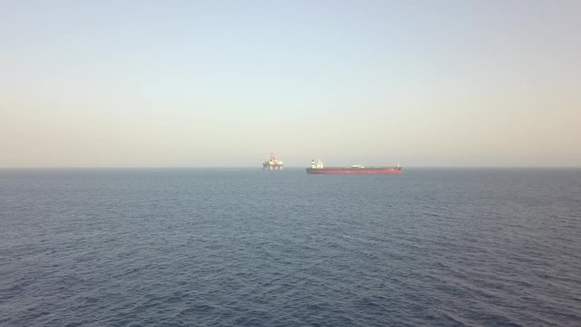 Aerial of semi-submersible drilling rig Scarabeo 9 and tanker vessel at anchorage area of Limassol