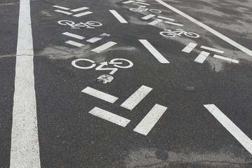 part of asphalt road with white bicycle marking