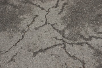 gray stone texture from cracks on asphalt road