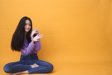 Isolated shot of pretty  Beautiful Asian models over pink  background for advertising  concept , wears casual outfit, being entertained by friend during party