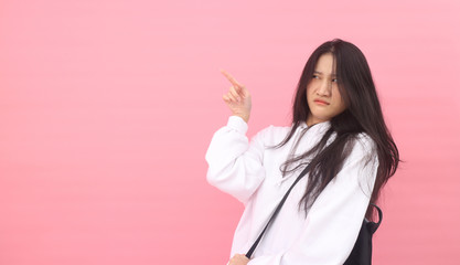 Isolated shot of pretty  Beautiful Asian models over pink  background for advertising  concept , wears casual outfit, being entertained by friend during party