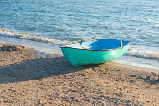 Fishing boat on the beach . Boat with oars