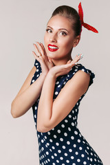 portrait of surprised pin up woman in polka dot dress. cute girl in retro style