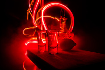 Club drink concept. Tasty alcohol drink cocktail tequila with lime and salt on vibrant dark...