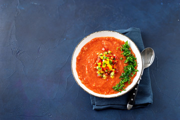 Gazpacho cold summer vegetarian tomato soup on blue table