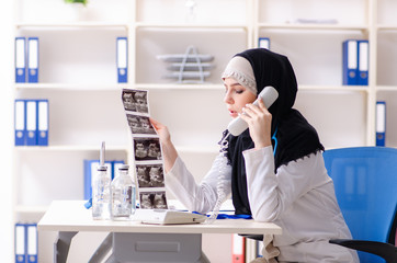 Young doctor in hijab working in the clinic 