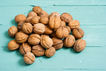 walnuts on blue wooden table background