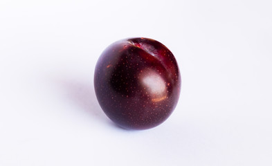 close up of a red cherry plum isolated