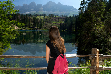 Lake Caress Dolomites Italy. Lake of Caresse in Italy. Scenic place and famous touristic destination. Primeval nature. girl on the lake