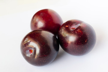 close up of red cherry plums isolated