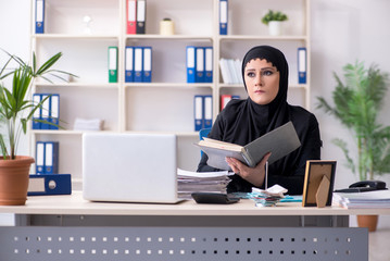 Female employee bookkeeper in hijab working in the office 