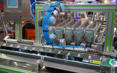 Robot lifting pouch for seal sensor inspection. Food industry
