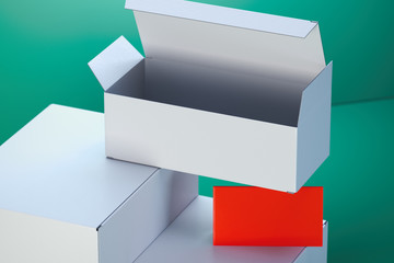 White cardboard boxes and red blank business card on green background. 3d rendering.
