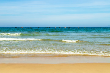 Golden beach, blue sea There are fishing boats to see far. And the blue sky