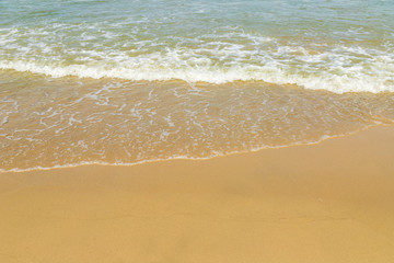 Soft beautiful ocean wave on sandy beach.