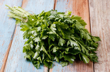 bunch of fresh parsley on a wooden table