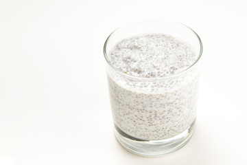 Chia pudding  in glass on a white background. Space for text or design.