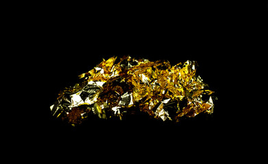 Scraps gold foil and empty space on black background