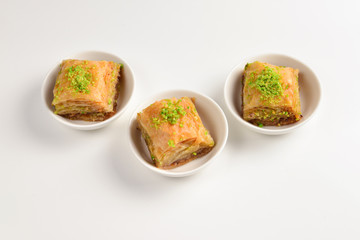 Pistachio baklava on a white background. Dessert.