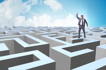 Businessman trying to escape from maze 