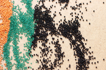 Different color Mardi Gras beads scattered on top of each other, giving a vibrant color splash...