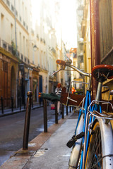 Fototapeta premium Blue classic vintage bicycle in street in Paris. It is showing the European green and healthy lifestyle and city life