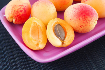 Ripe organic apricots in a plate