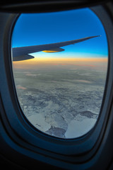 Out side above view from airplane side windows when sunrise, transportation and traveler concept